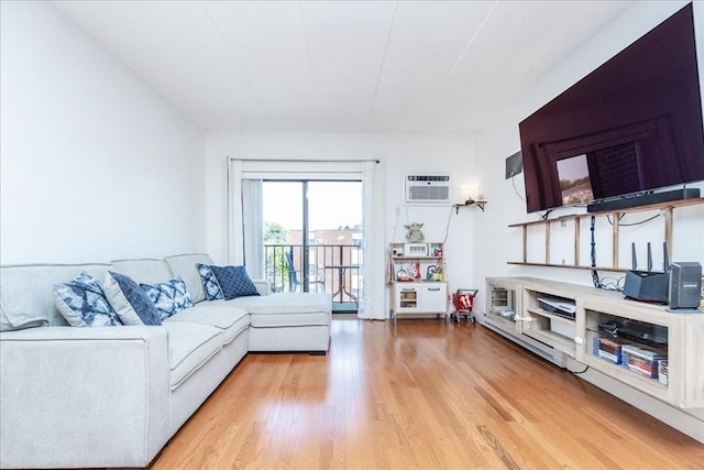living room featuring light wood finished floors and an AC wall unit