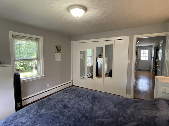 412 Worcester St, West Boylston, MA 01583 - unfurnished bedroom featuring a baseboard radiator, a closet, and wood finished floors