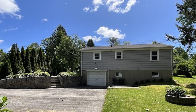 412 Worcester St, West Boylston, MA 01583 - back of property featuring asphalt driveway, a lawn, and a garage