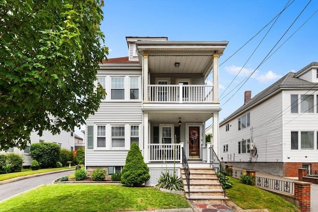 130 Francis St, Everett, MA 02149 - view of front of home featuring a balcony, covered porch, and a front yard