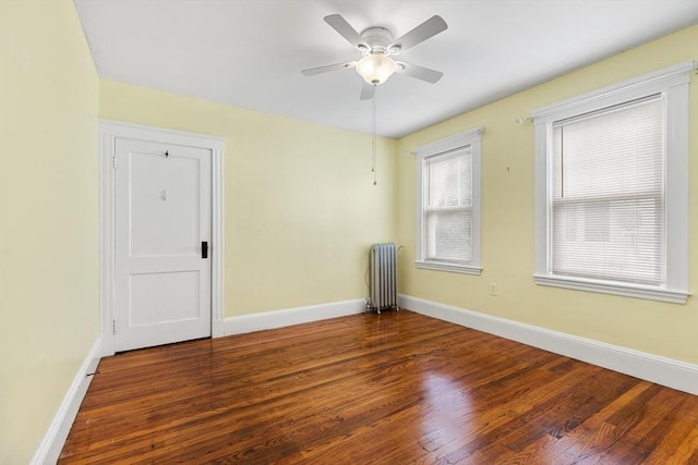 130 Francis St, Everett, MA 02149 - spare room featuring radiator, wood finished floors, and a ceiling fan