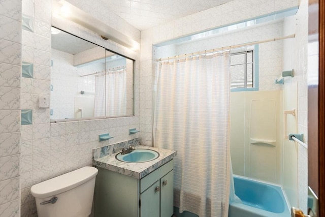130 Francis St, Everett, MA 02149 - bathroom with tile walls, vanity, and shower / tub combo