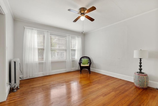130 Francis St, Everett, MA 02149 - unfurnished room with radiator heating unit, a ceiling fan, light wood-style floors, and ornamental molding