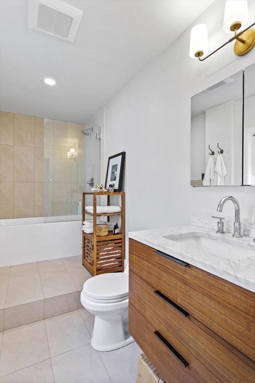 full bathroom with toilet, tub / shower combination, tile patterned floors, visible vents, and vanity