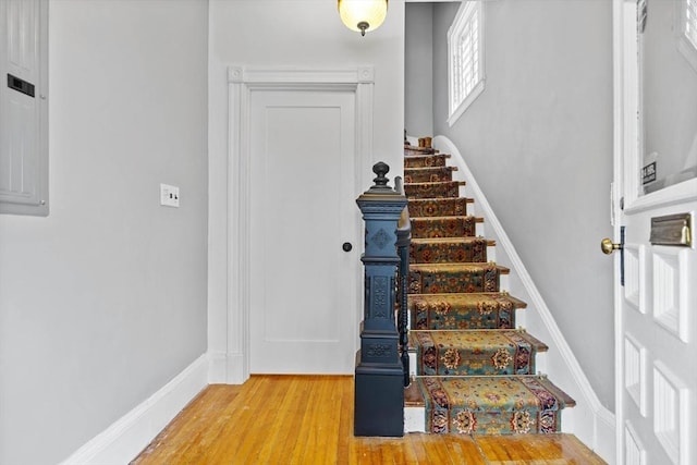 entrance foyer with baseboards, stairs, and light wood finished floors