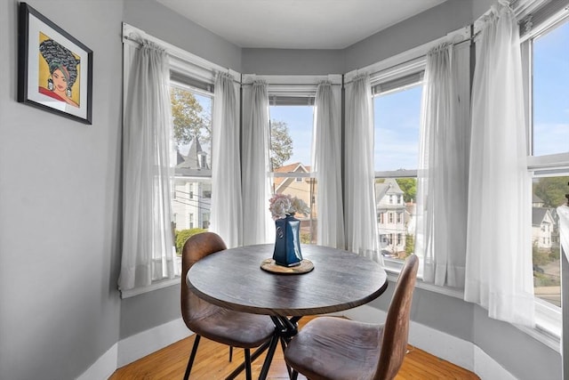 dining room with light wood-style flooring and baseboards