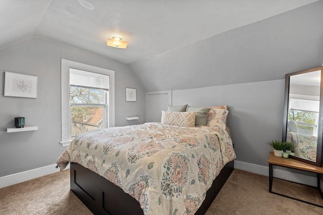 carpeted bedroom featuring vaulted ceiling and baseboards