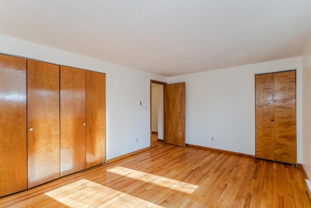 unfurnished bedroom with light wood finished floors and baseboards