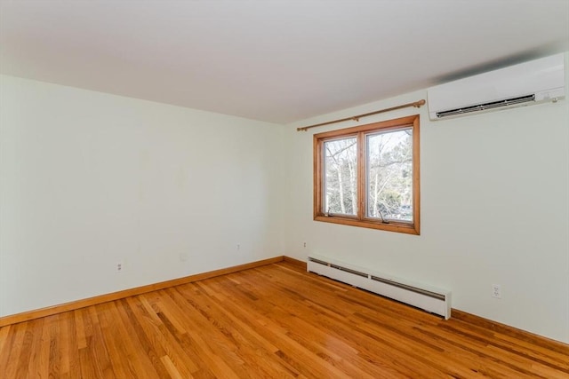 unfurnished room featuring a wall mounted air conditioner, light wood-type flooring, baseboards, and a baseboard radiator