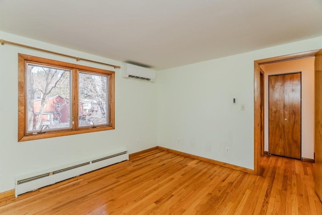 unfurnished room with baseboards, baseboard heating, an AC wall unit, and light wood-style flooring