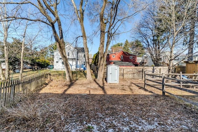 view of yard featuring a fenced backyard, a storage shed, and an outdoor structure