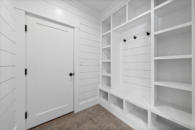 mudroom featuring wood walls