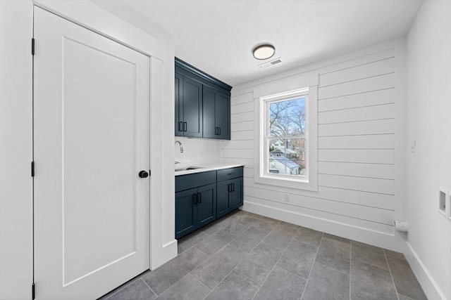 interior space featuring visible vents, a sink, and baseboards