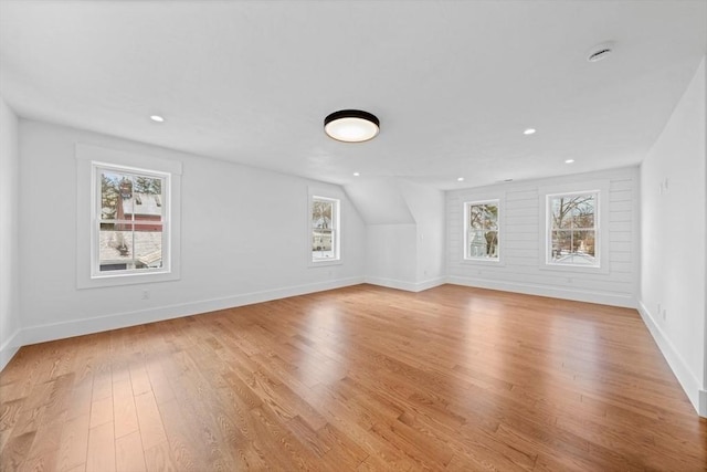 bonus room with recessed lighting, light wood-style flooring, and baseboards