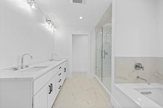 bathroom with marble finish floor, a sink, a marble finish shower, and a tub