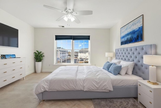 bedroom featuring baseboards, visible vents, and a ceiling fan