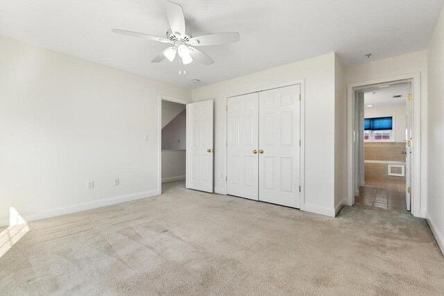 unfurnished bedroom with carpet, a closet, visible vents, and baseboards