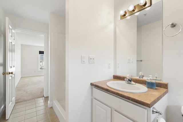 full bath featuring toilet, vanity, baseboards, tile patterned floors, and walk in shower