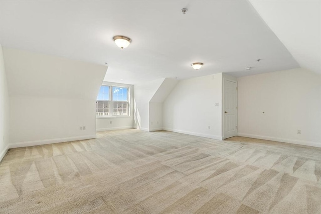 bonus room with light carpet, baseboards, and lofted ceiling