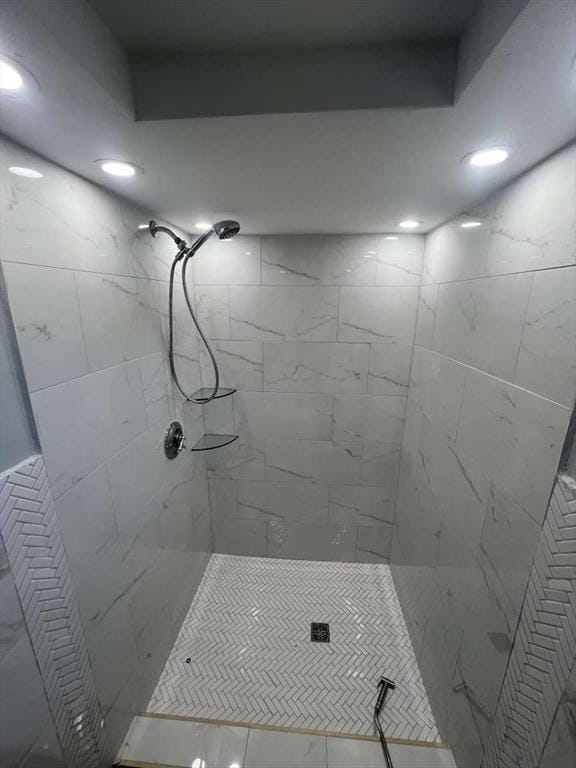 bathroom with a tile shower and recessed lighting