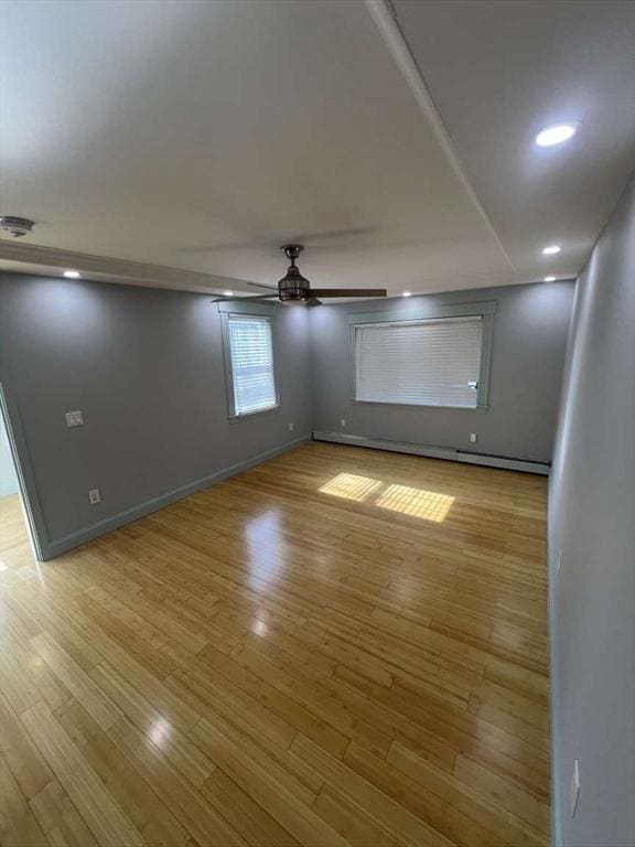 empty room featuring a ceiling fan, light wood-type flooring, baseboards, a smoke detector, and recessed lighting