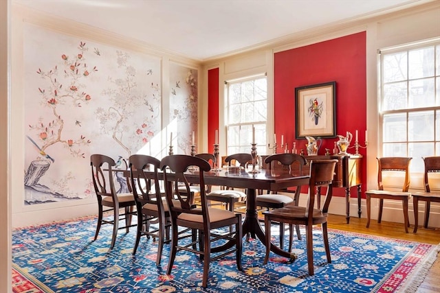 dining area featuring baseboards, ornamental molding, and wood finished floors