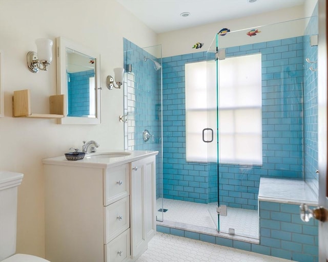 full bathroom featuring vanity, tile patterned flooring, a stall shower, and toilet