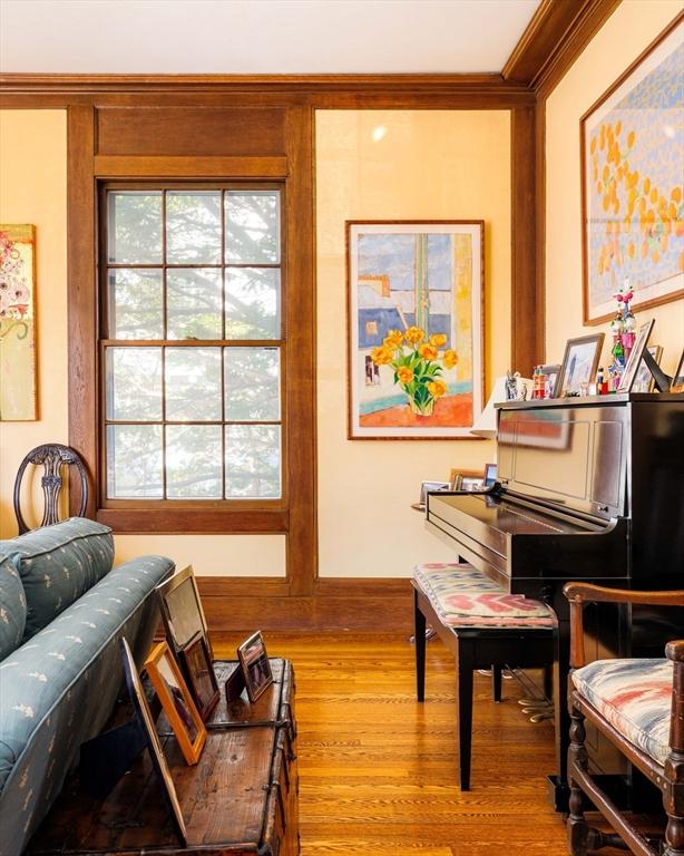 sitting room with crown molding and wood finished floors