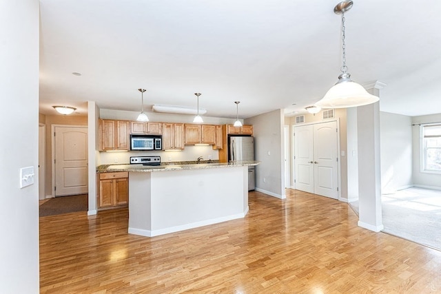 kitchen featuring hanging light fixtures, light wood-type flooring, and appliances with stainless steel finishes