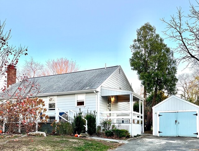 view of front facade with a porch, a garage, and an outdoor structure