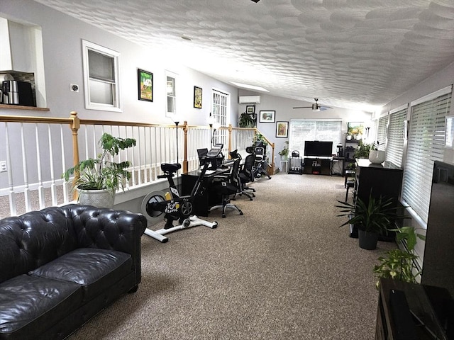 interior space with a textured ceiling, a ceiling fan, and vaulted ceiling