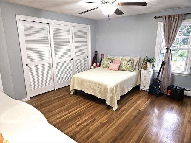 bedroom featuring a closet, dark wood finished floors, and a ceiling fan