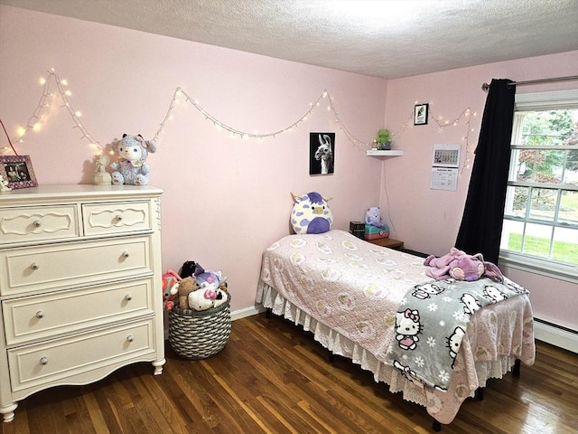 bedroom with dark wood finished floors, multiple windows, baseboards, and a textured ceiling