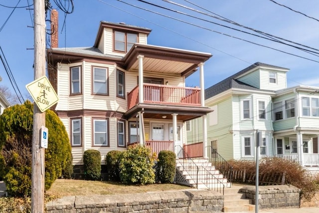 view of front of house featuring a balcony and covered porch