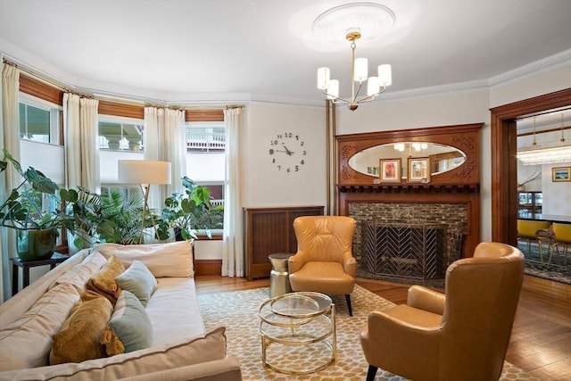 9 Arlington Rd, Woburn, MA 01801 - living area featuring a chandelier, a fireplace, crown molding, and wood finished floors