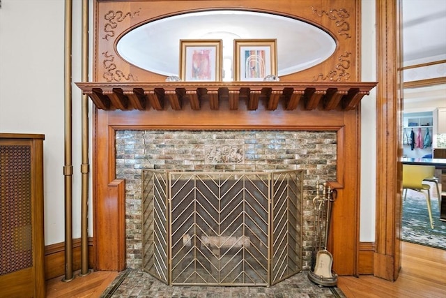 9 Arlington Rd, Woburn, MA 01801 - detailed view of a brick fireplace and wood finished floors