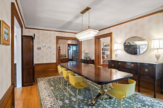 9 Arlington Rd, Woburn, MA 01801 - dining area with wallpapered walls, light wood-style floors, a chandelier, ornamental molding, and a wainscoted wall