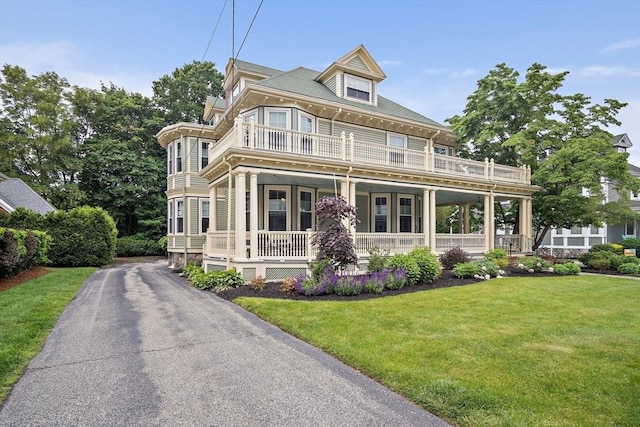 9 Arlington Rd, Woburn, MA 01801 - view of front facade featuring a balcony, a porch, and a front yard