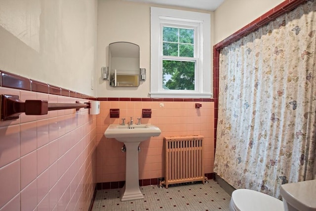 9 Arlington Rd, Woburn, MA 01801 - full bathroom featuring radiator, a wainscoted wall, curtained shower, and tile walls