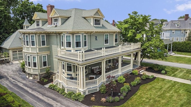 9 Arlington Rd, Woburn, MA 01801 - rear view of property with a balcony, a chimney, a yard, and driveway