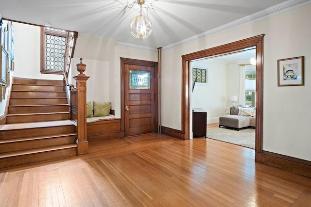 9 Arlington Rd, Woburn, MA 01801 - foyer entrance with hardwood / wood-style floors, stairway, a chandelier, and ornamental molding