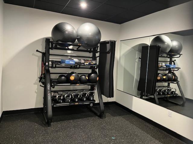 workout area with a paneled ceiling