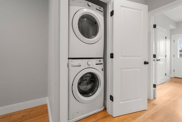 123-125 Centre St Unit Th4, Boston, MA 02124 - washroom featuring laundry area, stacked washer / dryer, and light wood-style floors