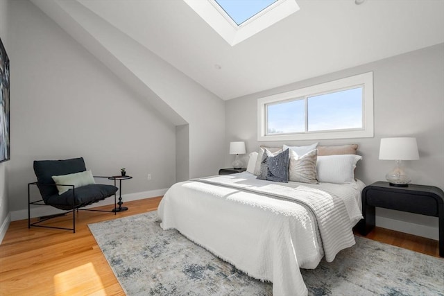 123-125 Centre St Unit Th4, Boston, MA 02124 - bedroom with light wood-style floors, baseboards, and vaulted ceiling with skylight