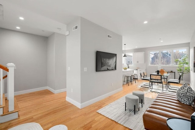 123-125 Centre St Unit Th4, Boston, MA 02124 - living room with stairs, recessed lighting, visible vents, and light wood-style flooring