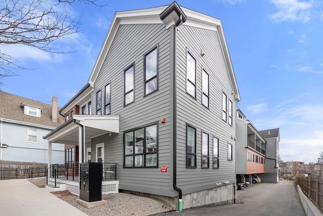 123-125 Centre St Unit Th4, Boston, MA 02124 - view of property exterior with a porch and fence