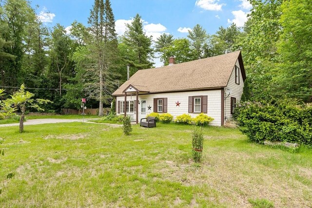 10 Worcester Rd, Townsend, MA 01469 - view of front facade featuring a chimney, a front lawn, and roof with shingles