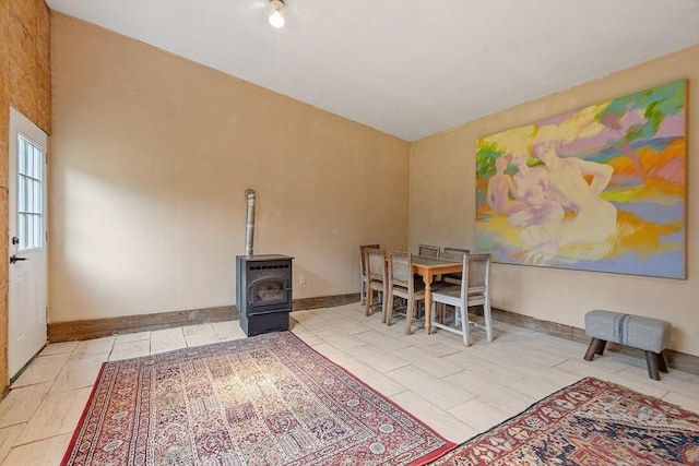 10 Worcester Rd, Townsend, MA 01469 - dining area featuring a wood stove, baseboards, and a high ceiling