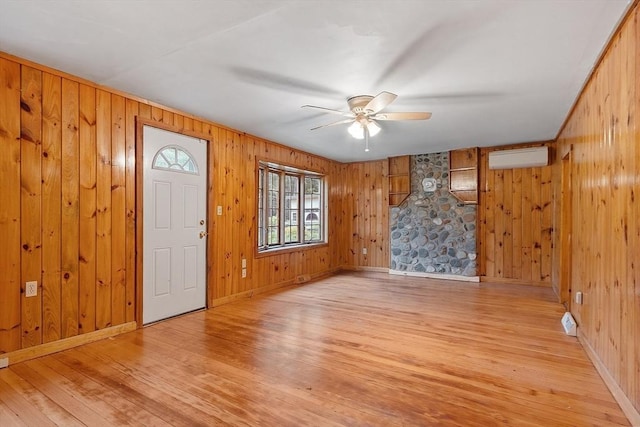 10 Worcester Rd, Townsend, MA 01469 - foyer entrance featuring wooden walls, light wood finished floors, ceiling fan, a wall unit AC, and baseboards