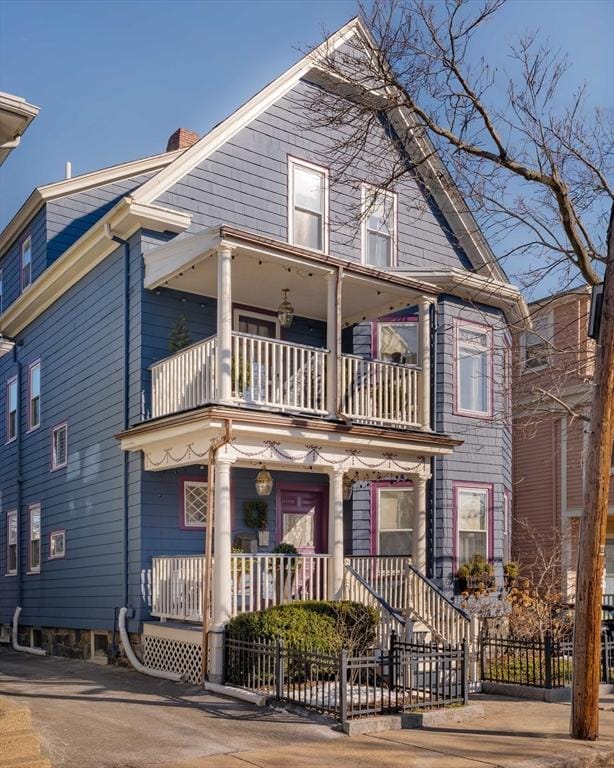 view of front of property with a balcony and covered porch